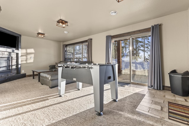 playroom with a wealth of natural light and a fireplace