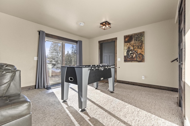 recreation room with light colored carpet
