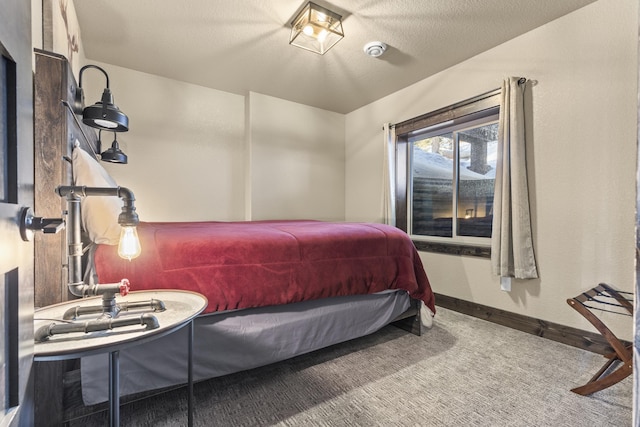 bedroom featuring a textured ceiling and carpet flooring