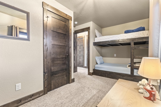 carpeted bedroom featuring a textured ceiling
