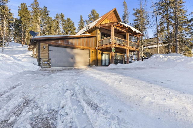 view of front of house with a wooden deck and a garage