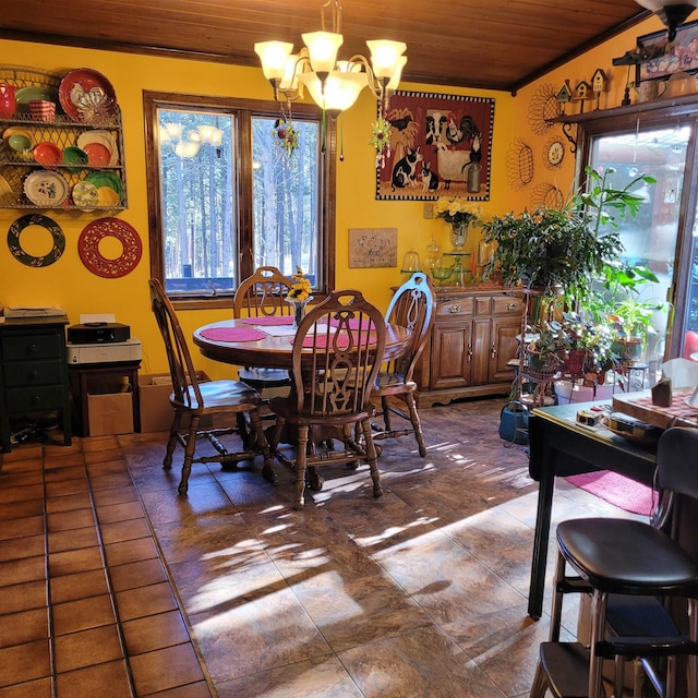 dining room featuring a healthy amount of sunlight, a notable chandelier, and wood ceiling