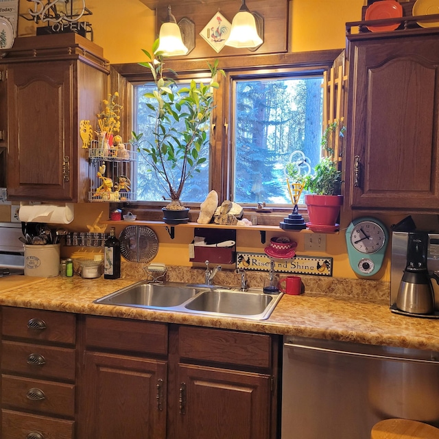 kitchen with sink, decorative light fixtures, a wealth of natural light, and stainless steel dishwasher