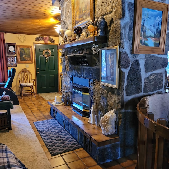 living room with a tile fireplace, wooden ceiling, and tile patterned floors