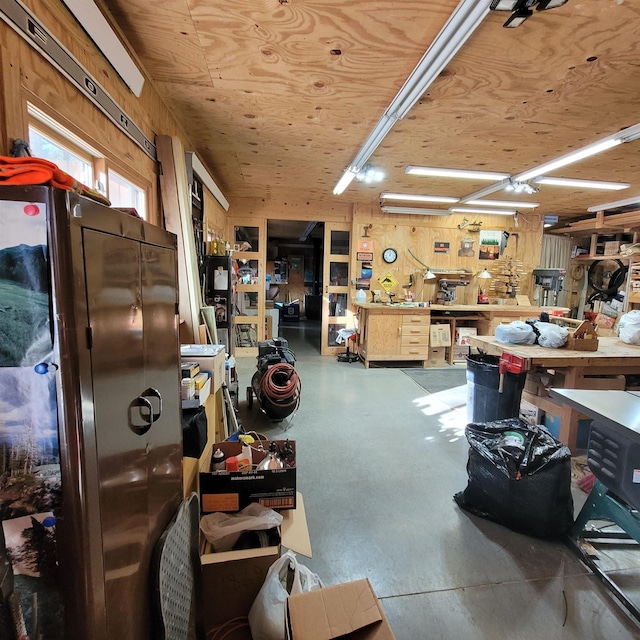 miscellaneous room with concrete floors and a workshop area