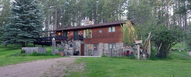 exterior space featuring a front lawn and a deck