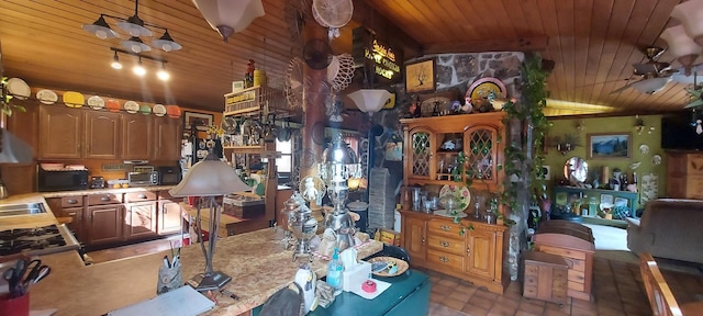 interior space with sink, wood ceiling, vaulted ceiling, and ceiling fan