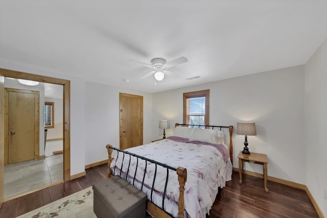 bedroom with dark hardwood / wood-style flooring and ceiling fan