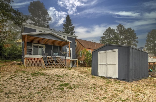 back of house with a shed