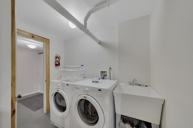 clothes washing area featuring sink and washing machine and clothes dryer