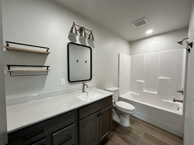 full bathroom featuring hardwood / wood-style flooring, vanity, toilet, and tub / shower combination