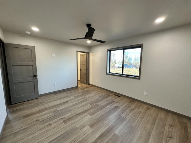 unfurnished bedroom featuring ceiling fan and light hardwood / wood-style flooring