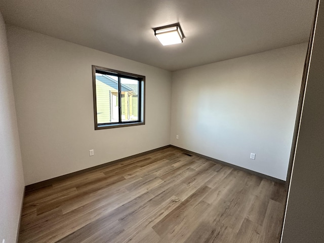 unfurnished room with light hardwood / wood-style floors