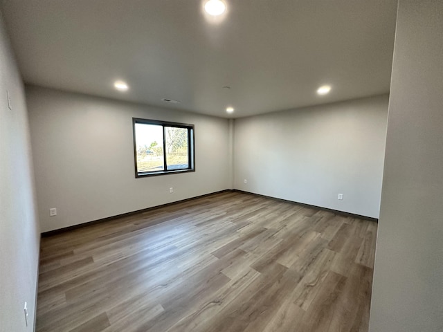 empty room with light hardwood / wood-style floors