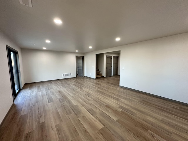 spare room with hardwood / wood-style flooring