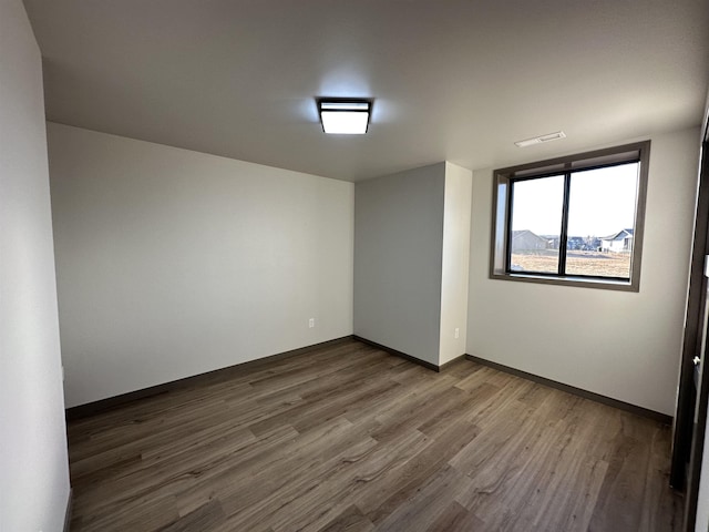 empty room with hardwood / wood-style floors