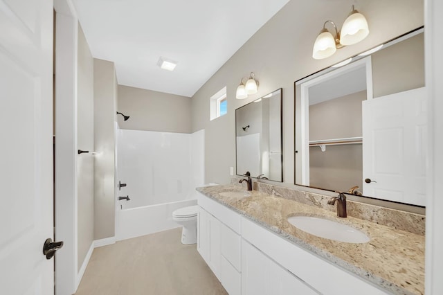 full bathroom featuring shower / bathtub combination, a sink, toilet, and double vanity