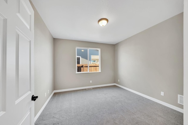 unfurnished room featuring carpet floors, baseboards, and visible vents