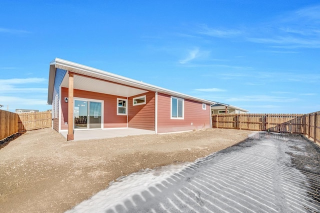 rear view of property with a patio area and a fenced backyard