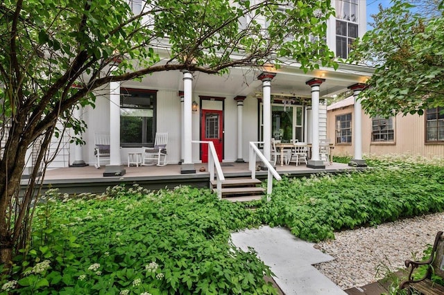 back of property with covered porch