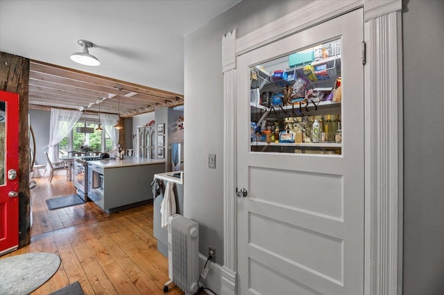 entryway featuring hardwood / wood-style floors and radiator heating unit