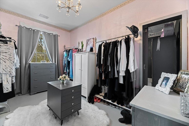 walk in closet featuring a notable chandelier