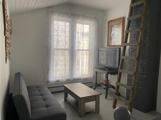 interior space featuring lofted ceiling, a baseboard heating unit, carpet floors, and a wealth of natural light