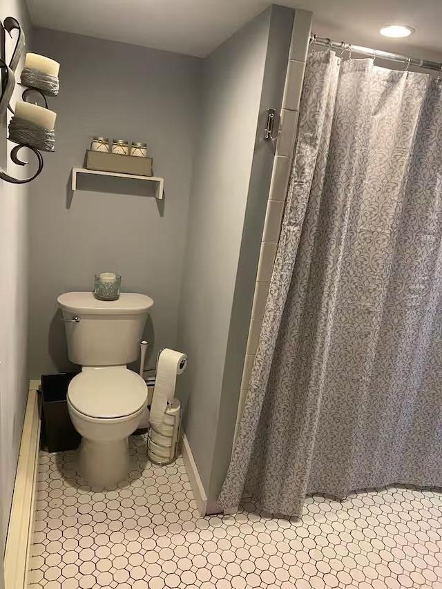 bathroom with walk in shower and toilet