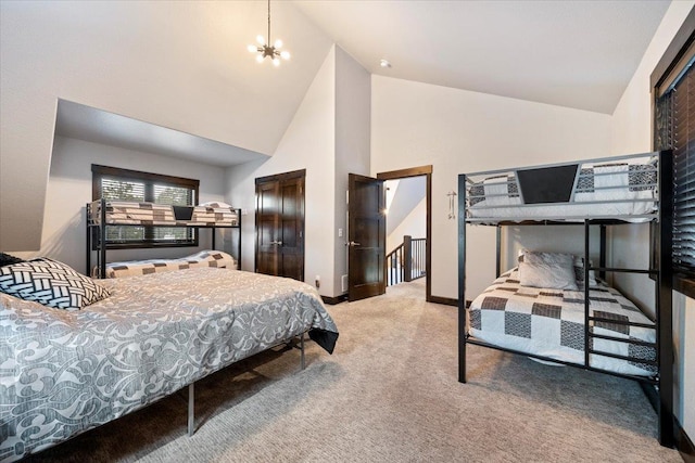 bedroom with an inviting chandelier, carpet floors, and high vaulted ceiling