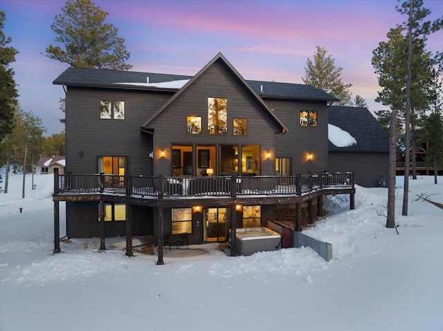 snow covered property with a deck