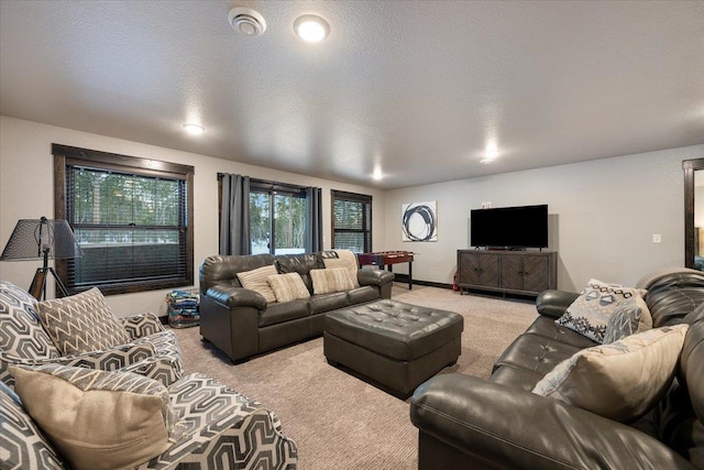 carpeted living room featuring a textured ceiling