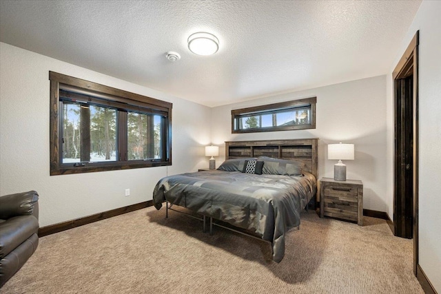 bedroom featuring light carpet, multiple windows, and a textured ceiling