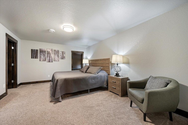 bedroom featuring light carpet and a textured ceiling