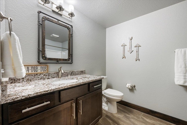 bathroom featuring vanity, wood-type flooring, and toilet