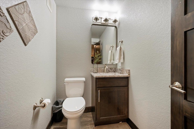 bathroom with vanity, wood-type flooring, and toilet