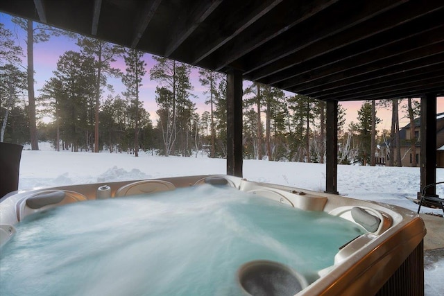 yard covered in snow featuring a hot tub