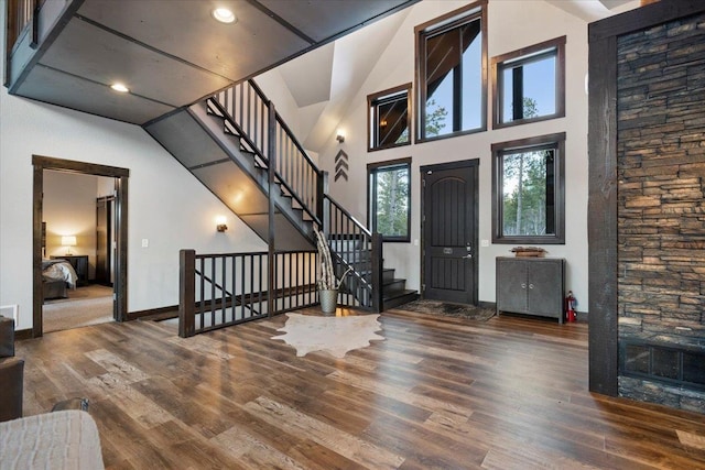 foyer with hardwood / wood-style flooring and a towering ceiling