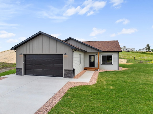 view of front of home with a garage and a front lawn