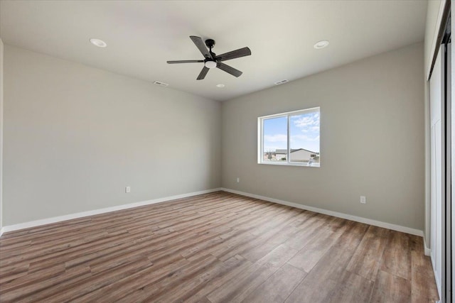 unfurnished room featuring light hardwood / wood-style floors and ceiling fan