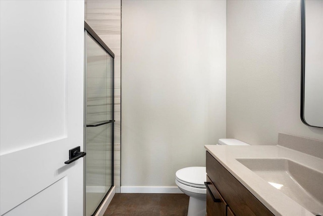 bathroom with vanity, an enclosed shower, and toilet