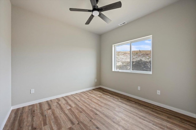 empty room featuring ceiling fan and light hardwood / wood-style flooring