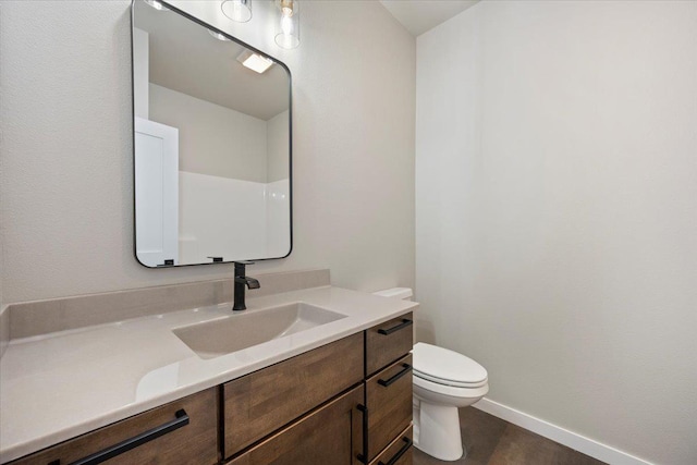 bathroom featuring vanity and toilet