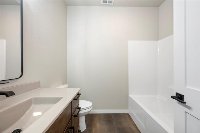 full bathroom with shower / bath combination, wood-type flooring, vanity, and toilet