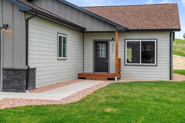 property entrance with a lawn