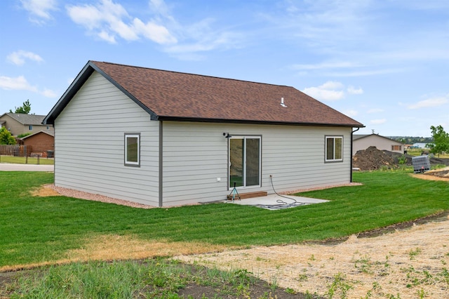 rear view of property featuring a yard