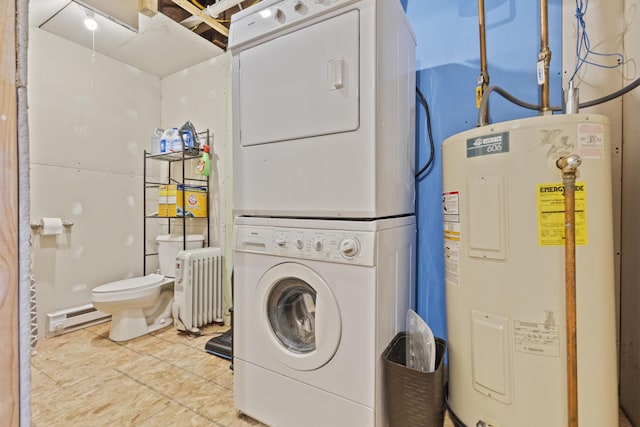 washroom with stacked washer and dryer, electric water heater, radiator, and baseboard heating