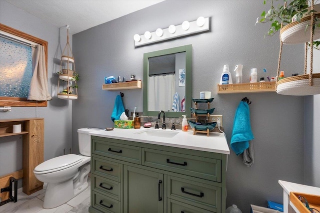 bathroom with vanity, toilet, and walk in shower