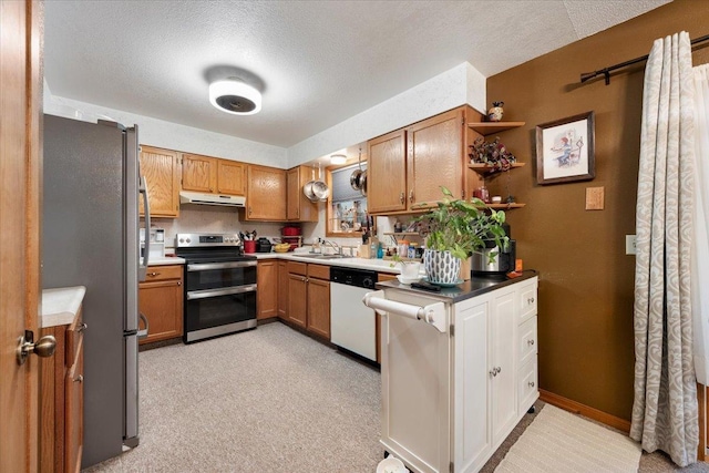 kitchen with stainless steel appliances, sink, and a textured ceiling