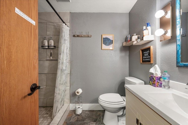 bathroom featuring vanity, toilet, and curtained shower