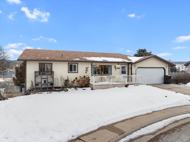 single story home with a garage and a porch